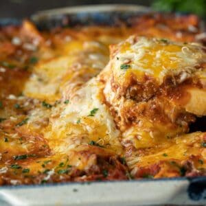 Beef Lasagna slice being lifted out of a plan