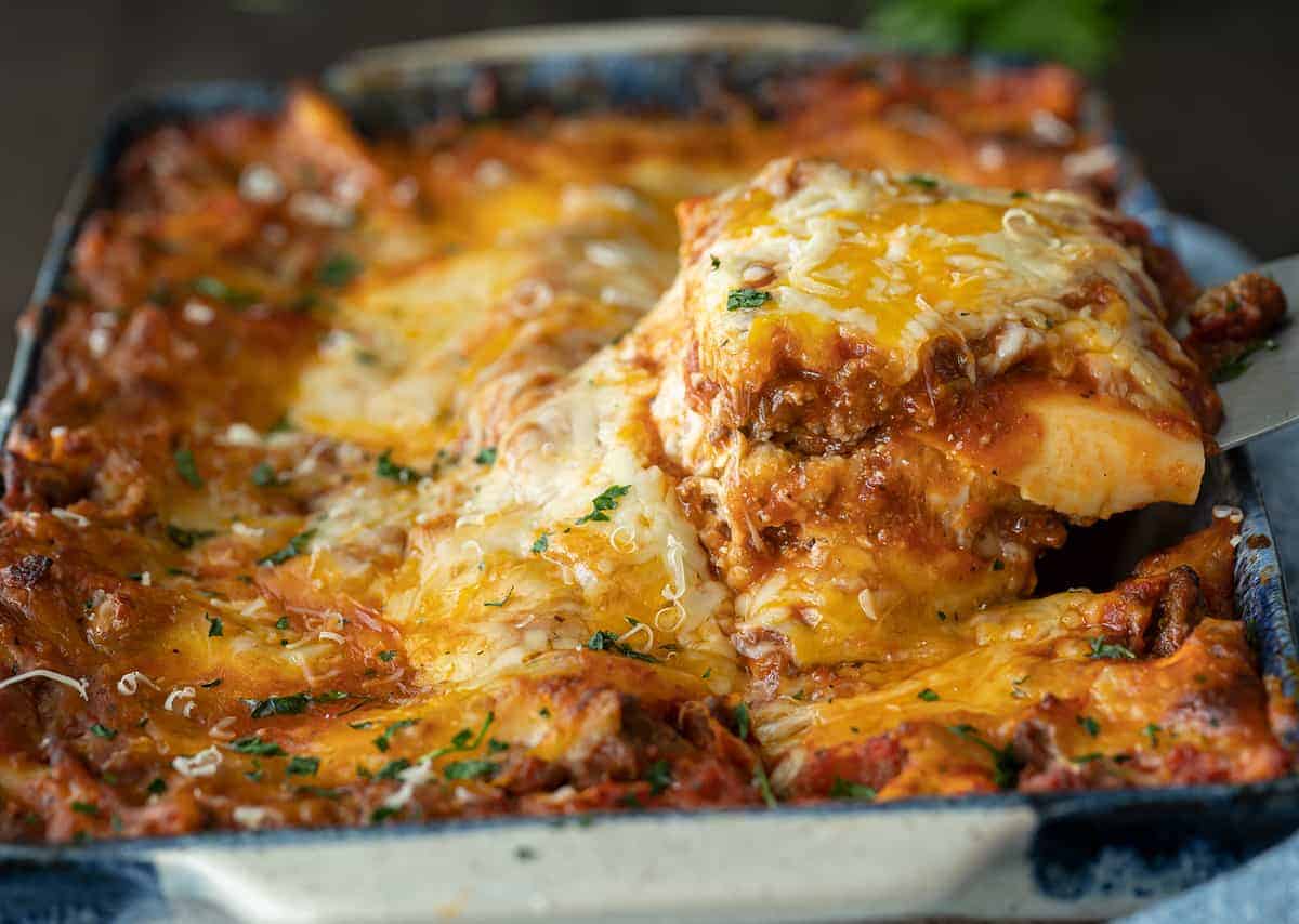 Beef Lasagna slice being lifted out of a plan