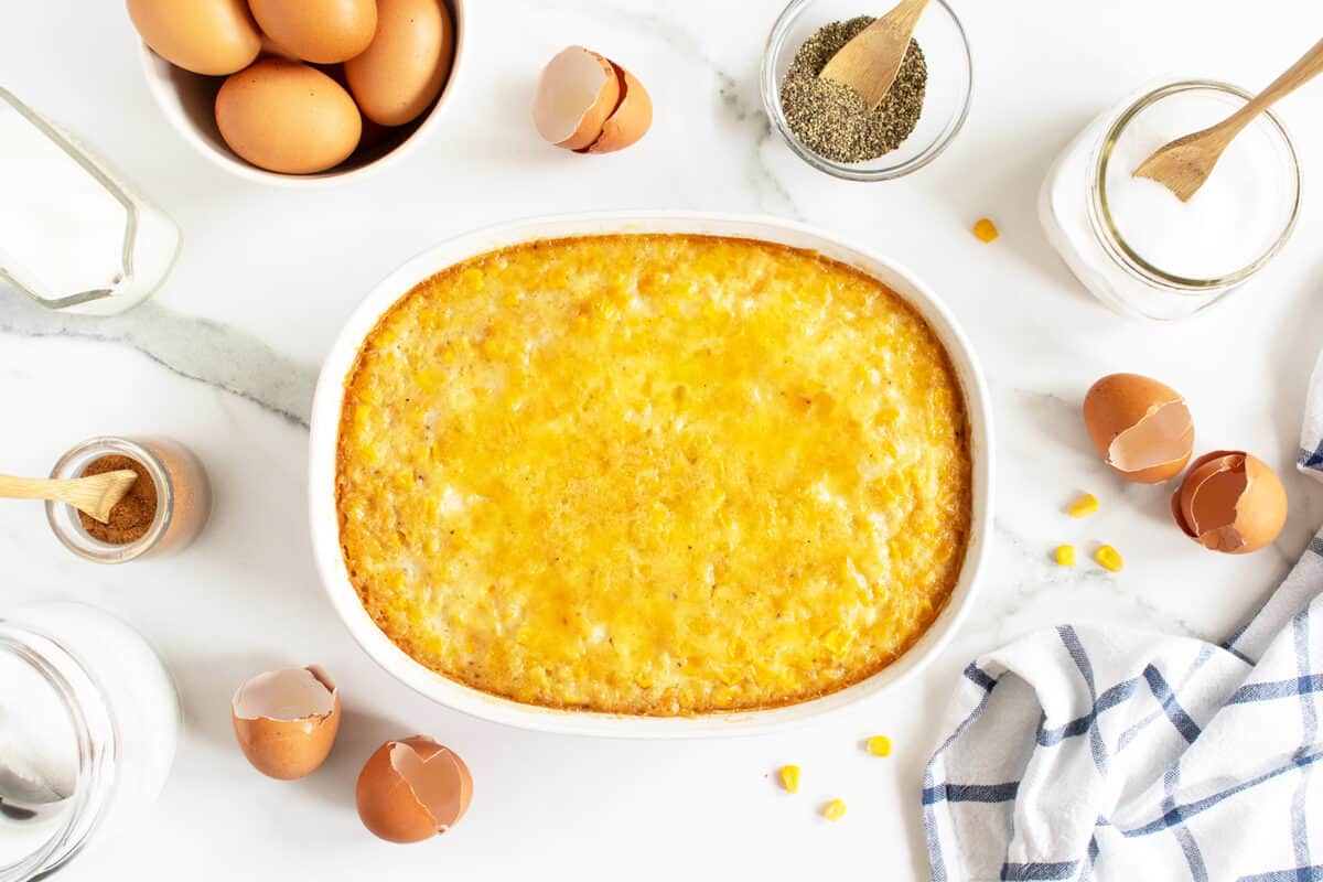 creamy corn pudding in a white casserole dish