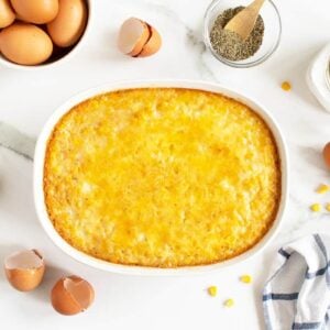 creamy corn pudding in a white casserole dish