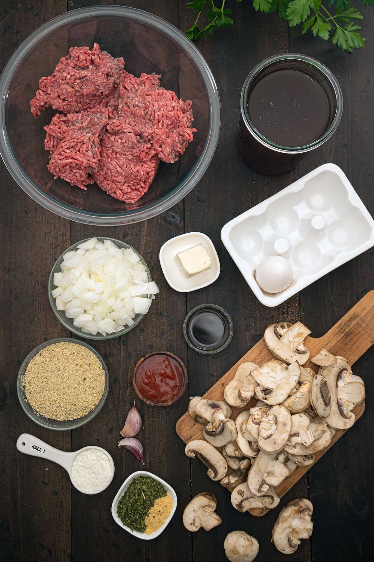 A top down shot of the Ingredients of salisbury steak, all layed out in bowls.