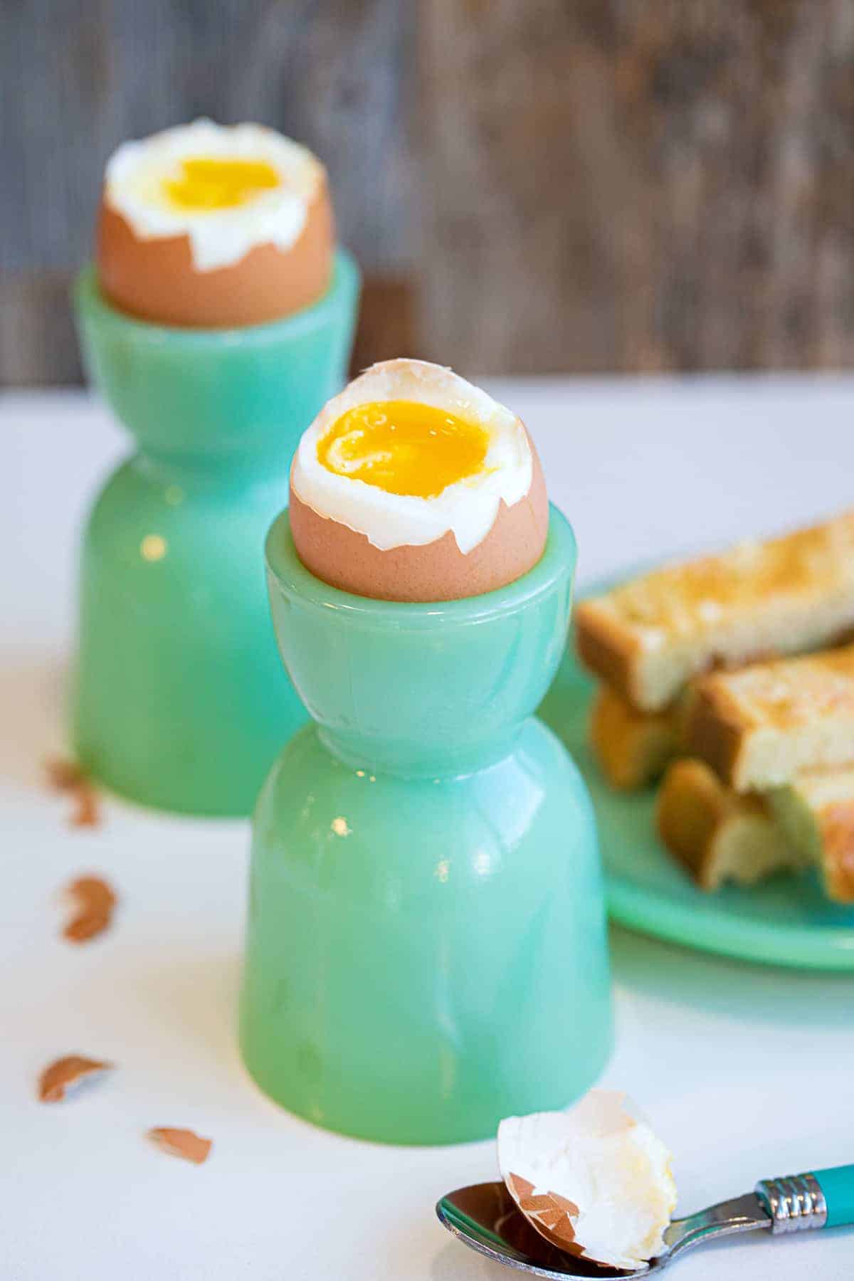 Close-up of soft boiled eggs with their tops removed