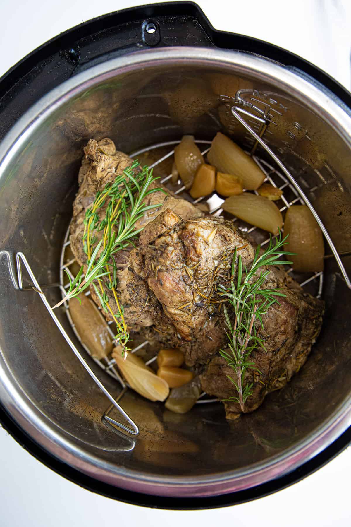 Top down shot of the ingredients of a pork roast inside an instant pot.