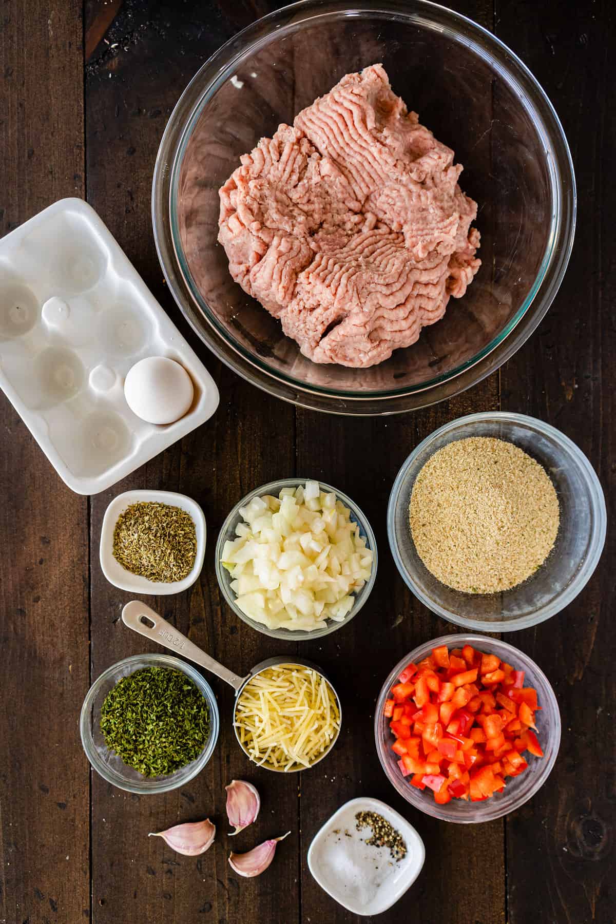 Component ingredients of a turkey meatloaf, all portioned out in bowls.