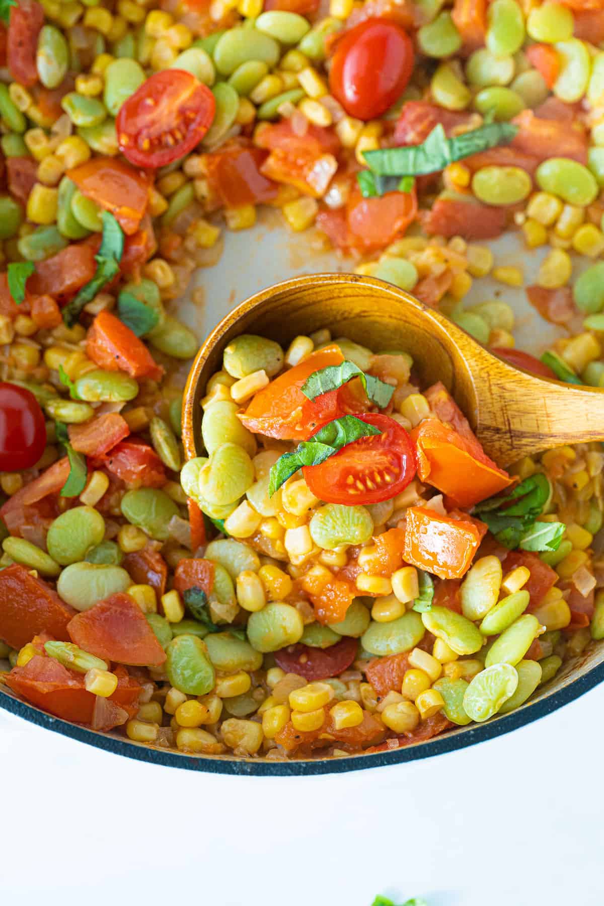 wooden spoon with succotash in it