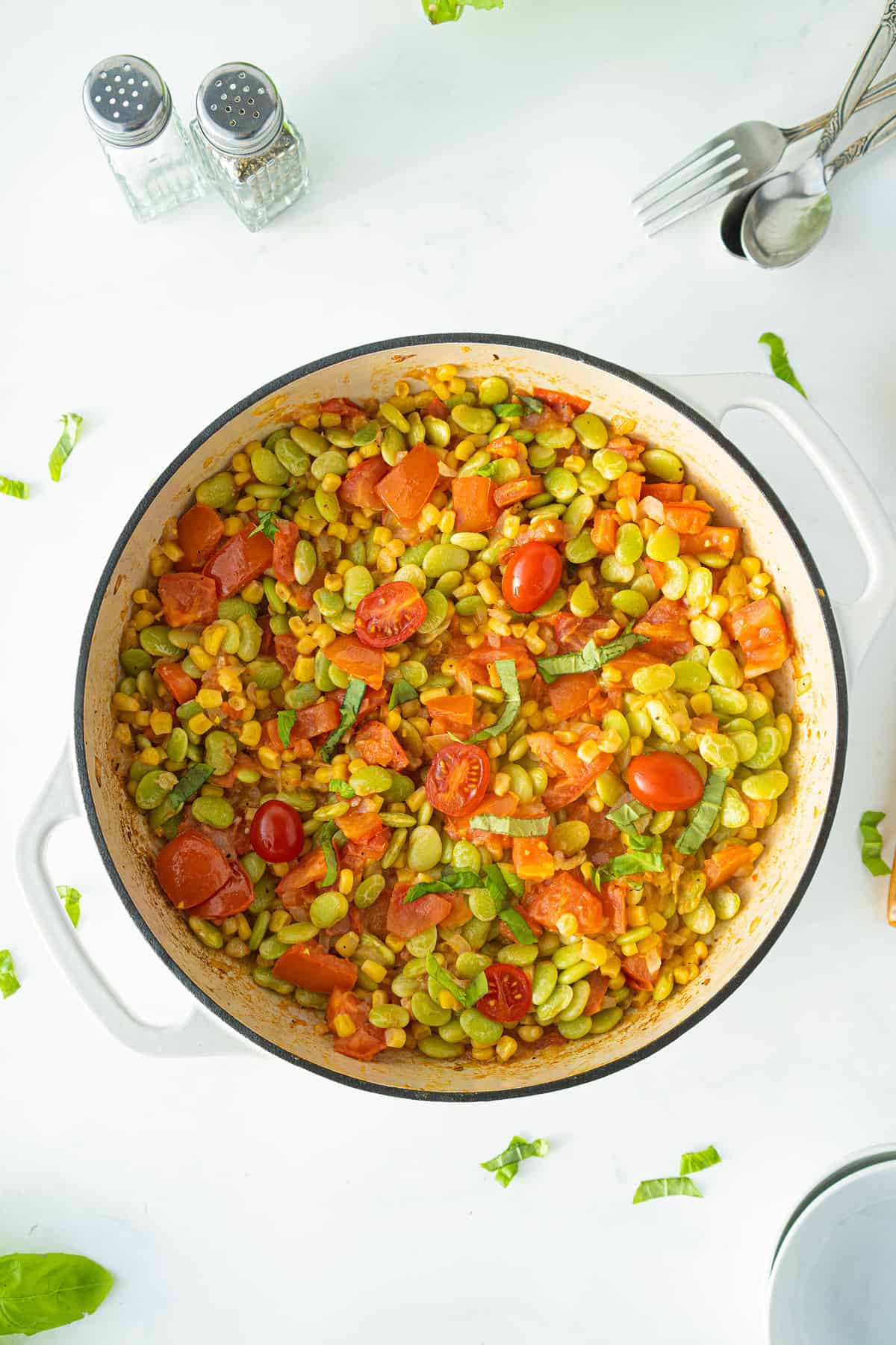 succotash in a white braising pan