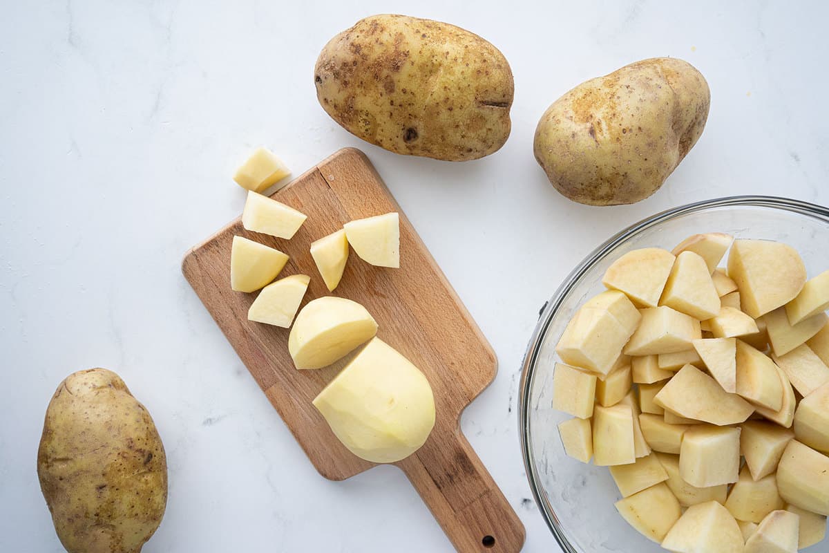 Russet potatoes on a cutting board