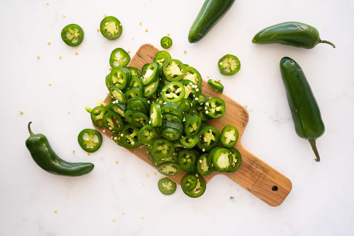 jalapeno peppers sliced on a cutting board