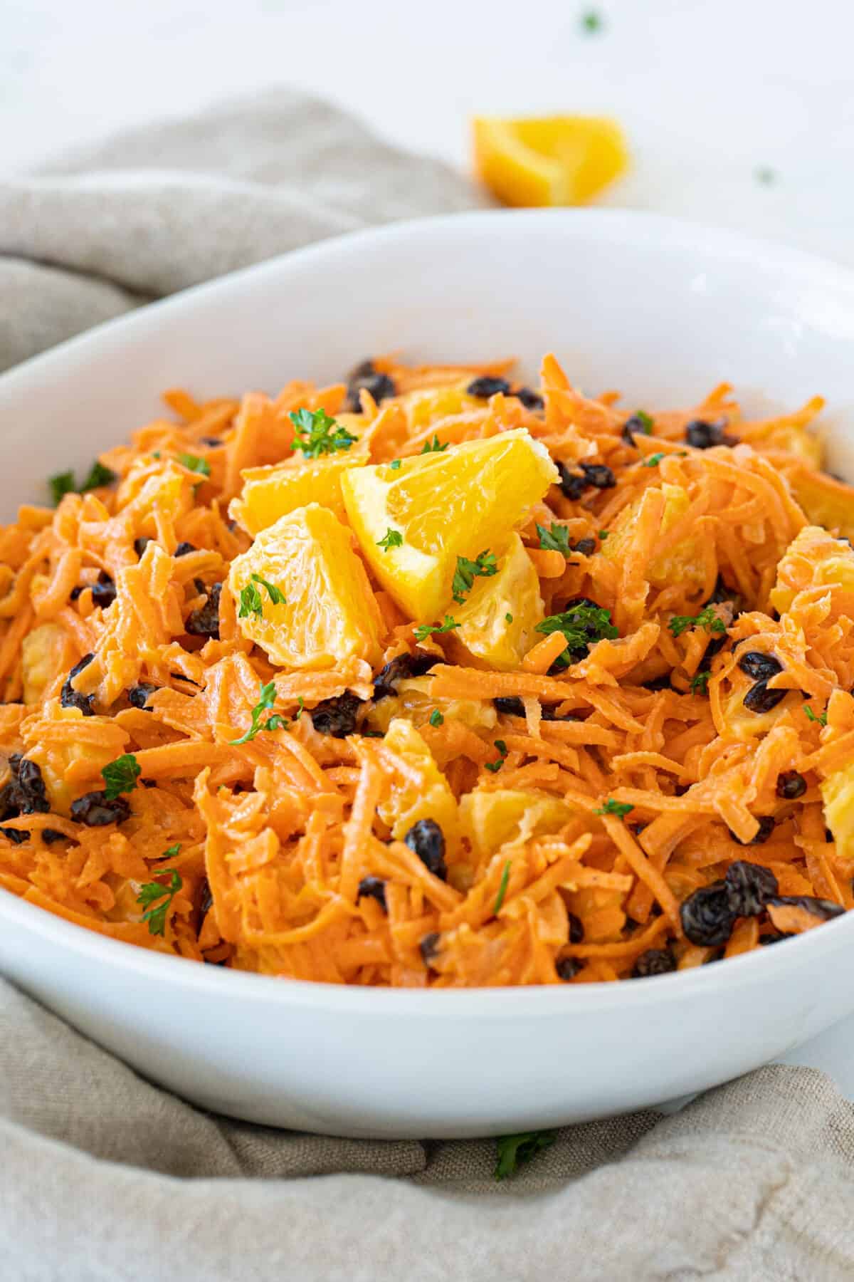 carrot raisin salad in large white bowl