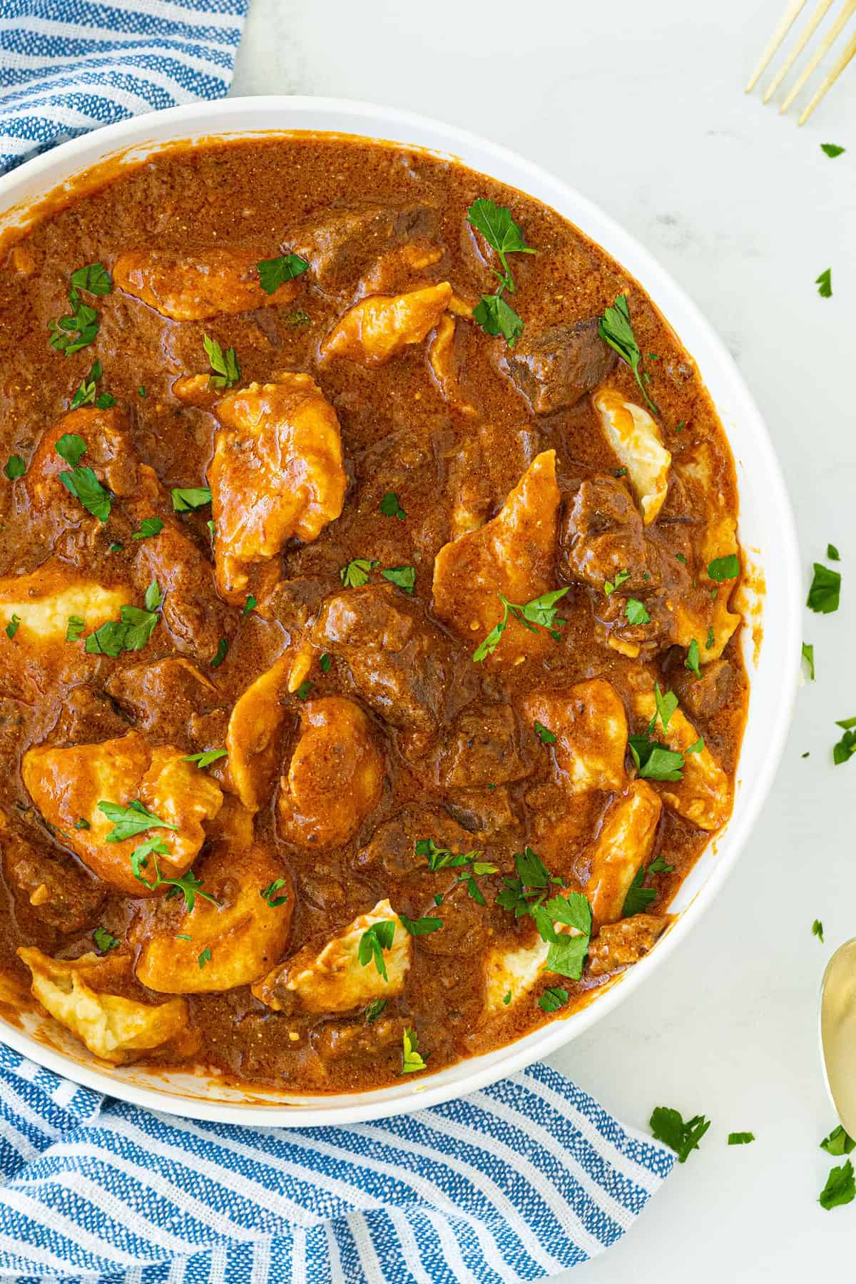 Hungarian Goulash with nokedli in a white bowl 