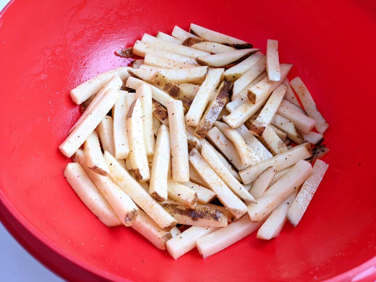 drizzle olive oil over the fries and season with seasoning salt.