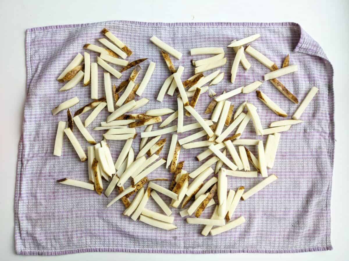 Dry Fries on Paper Towels or a clean dish towel to remove water