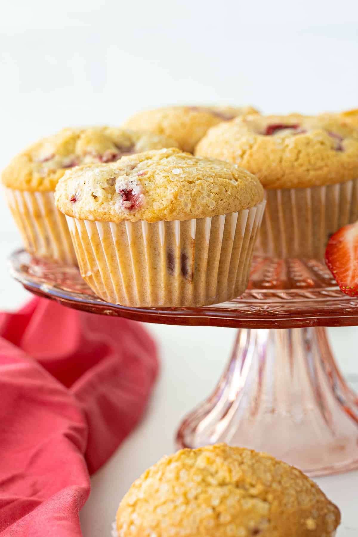 close up of strawberry muffins on a pink platter