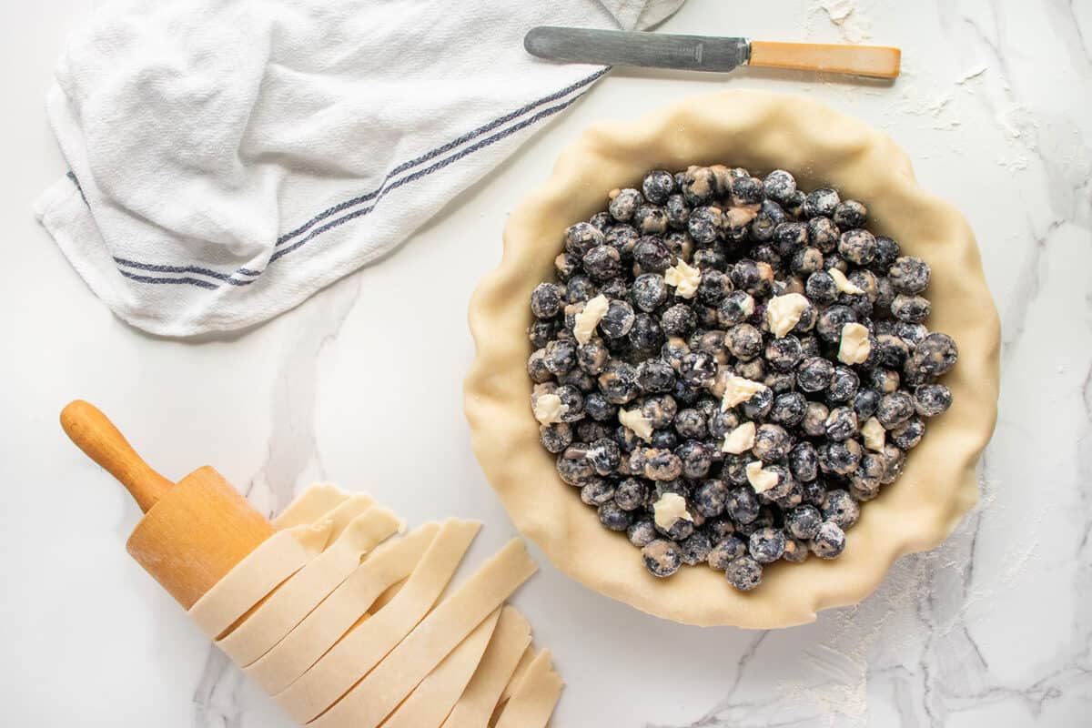 blueberries in a pie plate with pastry