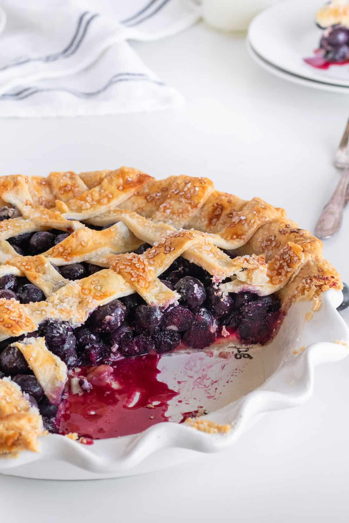 slice of blueberry pie in a pie plate