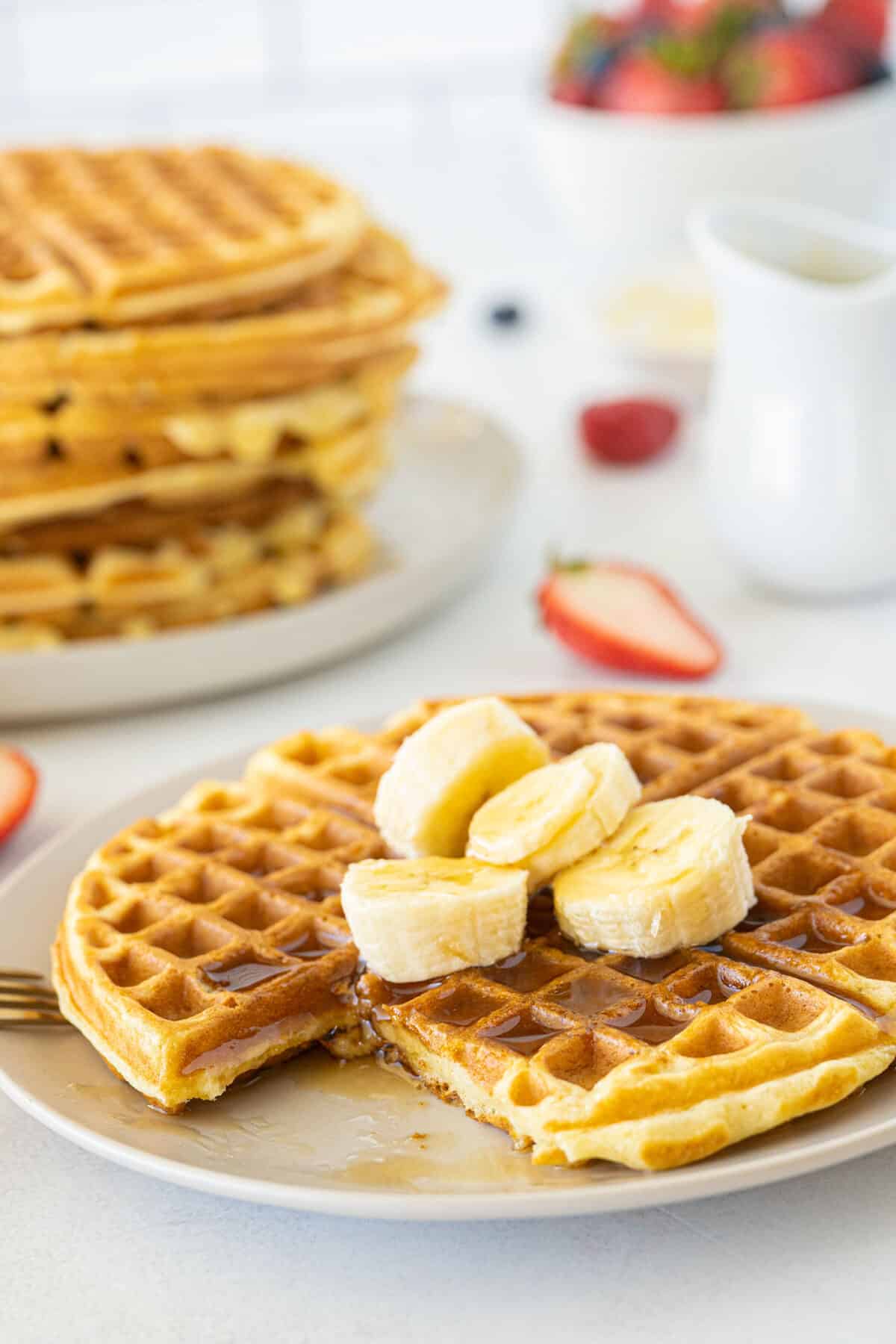 sliced buttermilk waffles with bananas and syrup on top