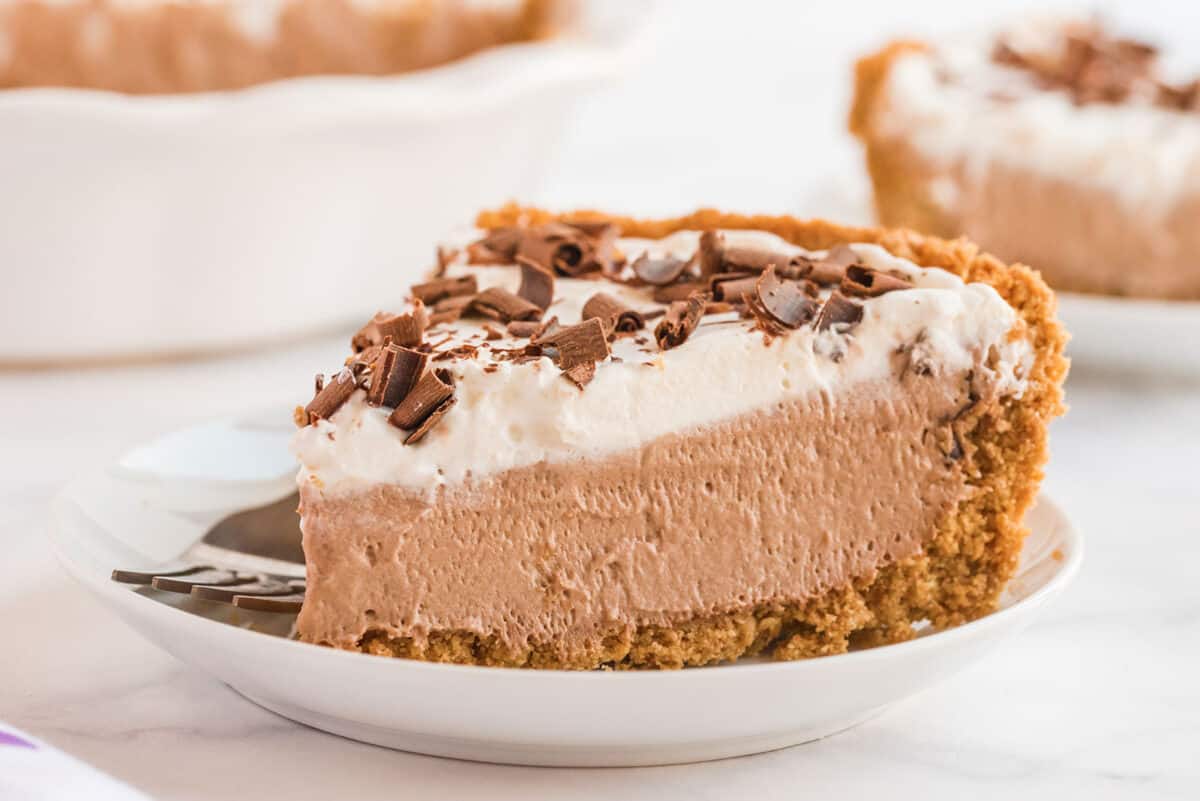 a large slice of chocolate mousse pie on a white plate