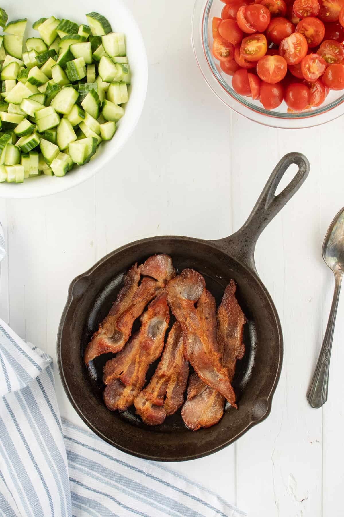 frying bacon in a cast iron skillet