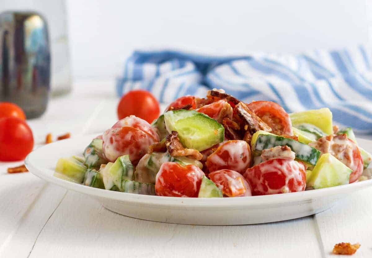 cucumber tomato Salad on a white plate