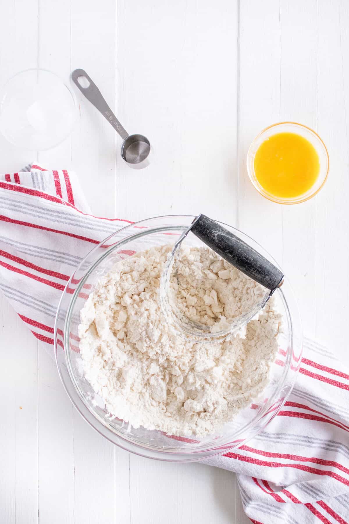 cutting the lard into the flour with a pastry blender