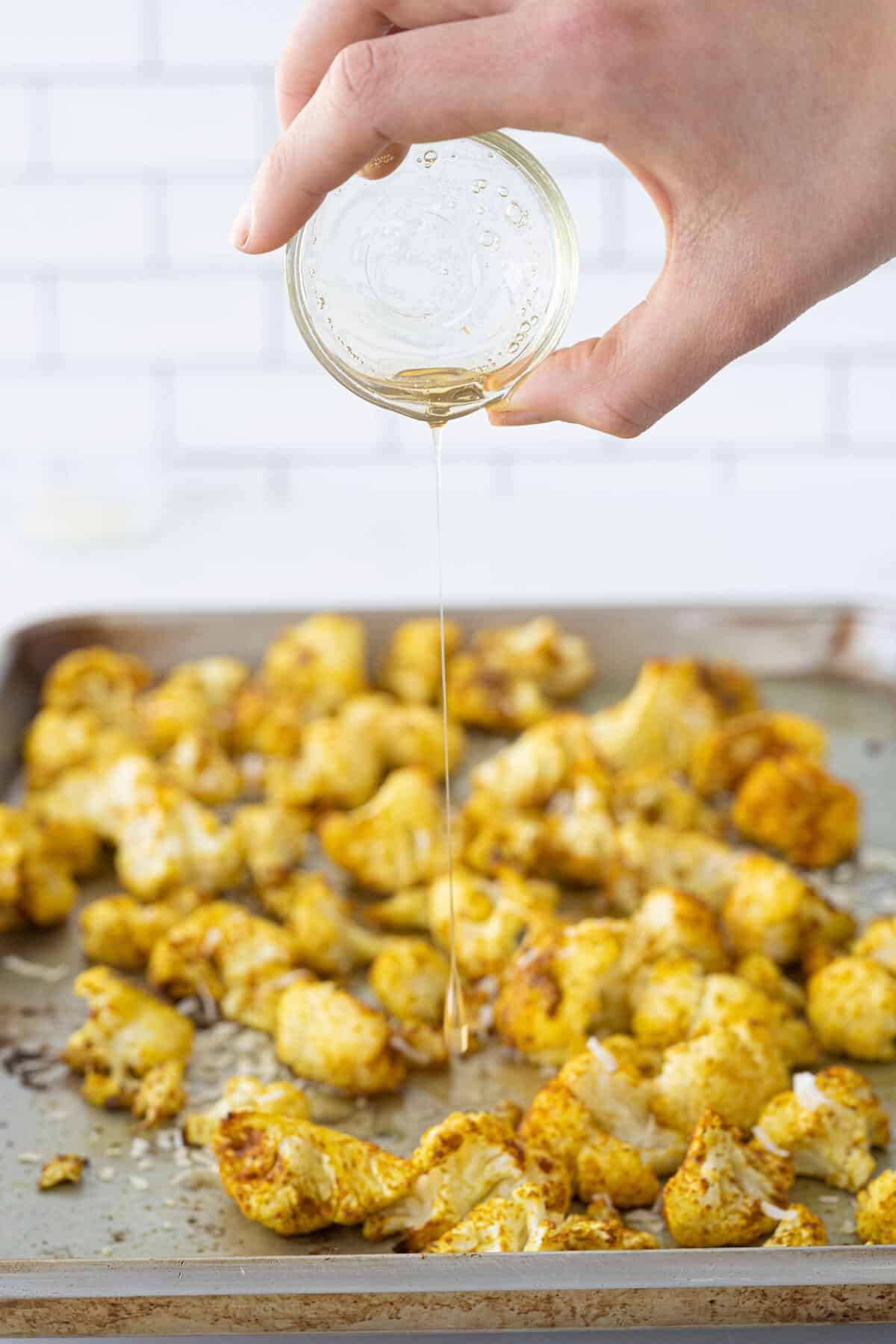 drizzling honey onto roasted cauliflower