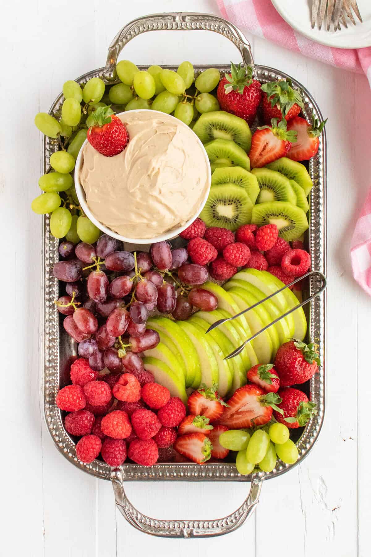 fruit dip on a silver platter surrounded by fruit