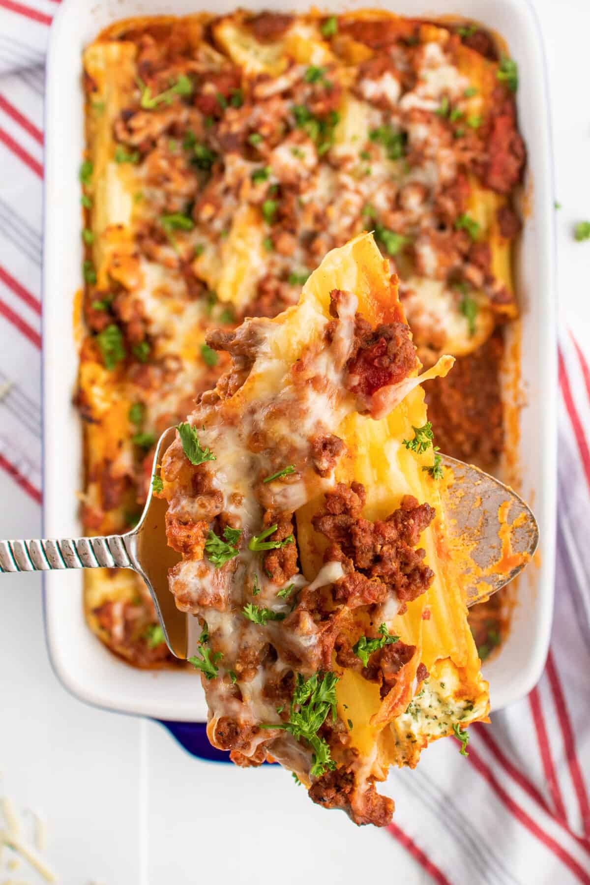 cheesy cooked manicotti on a spatula 