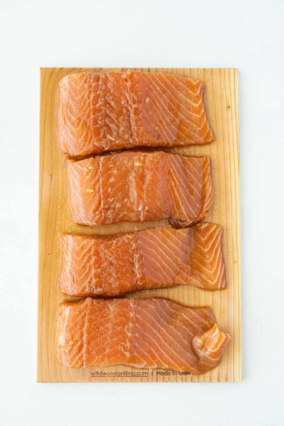 marinated raw salmon on a cedar board