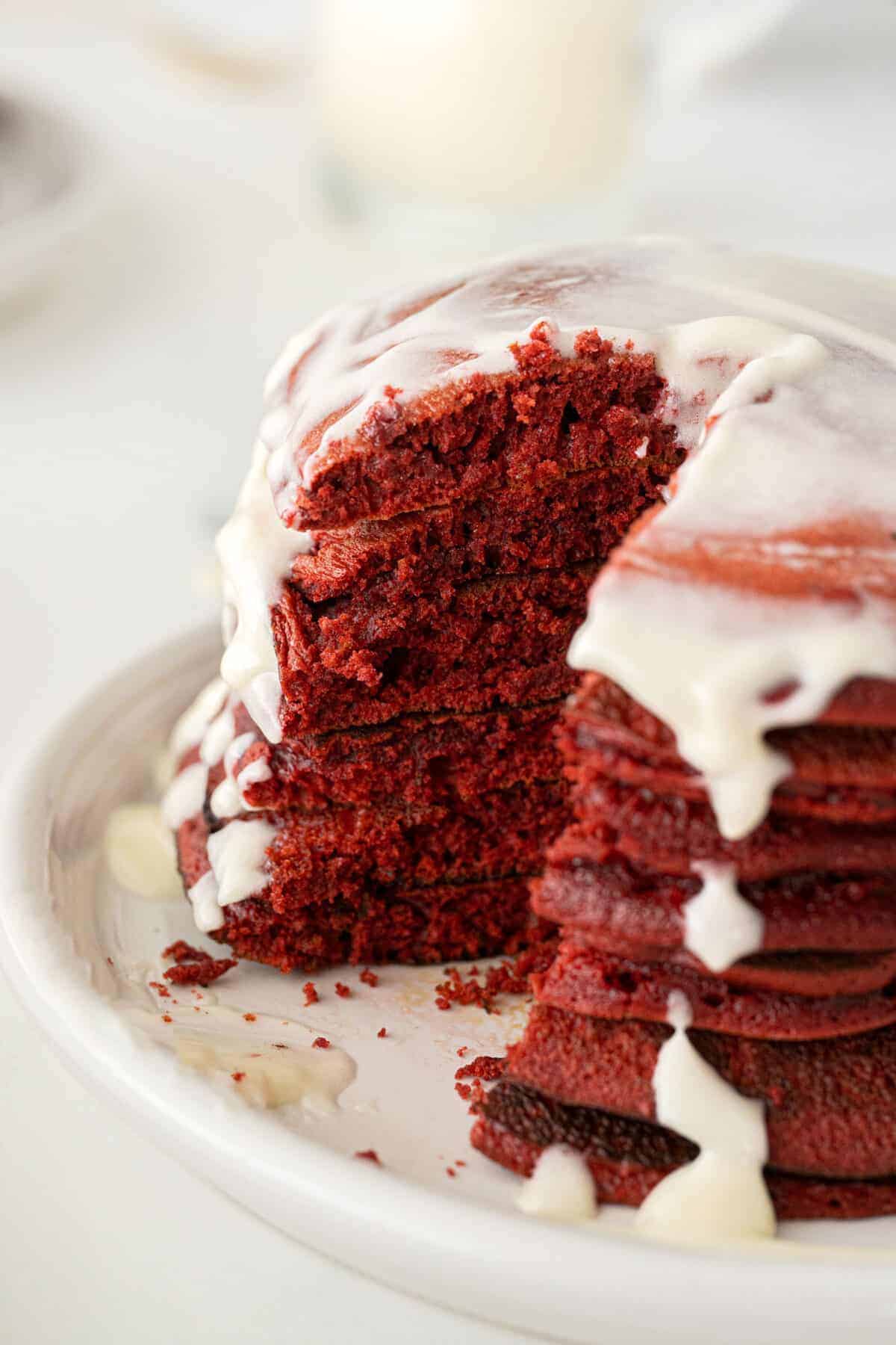stack of red velvet pancakes on a white plate