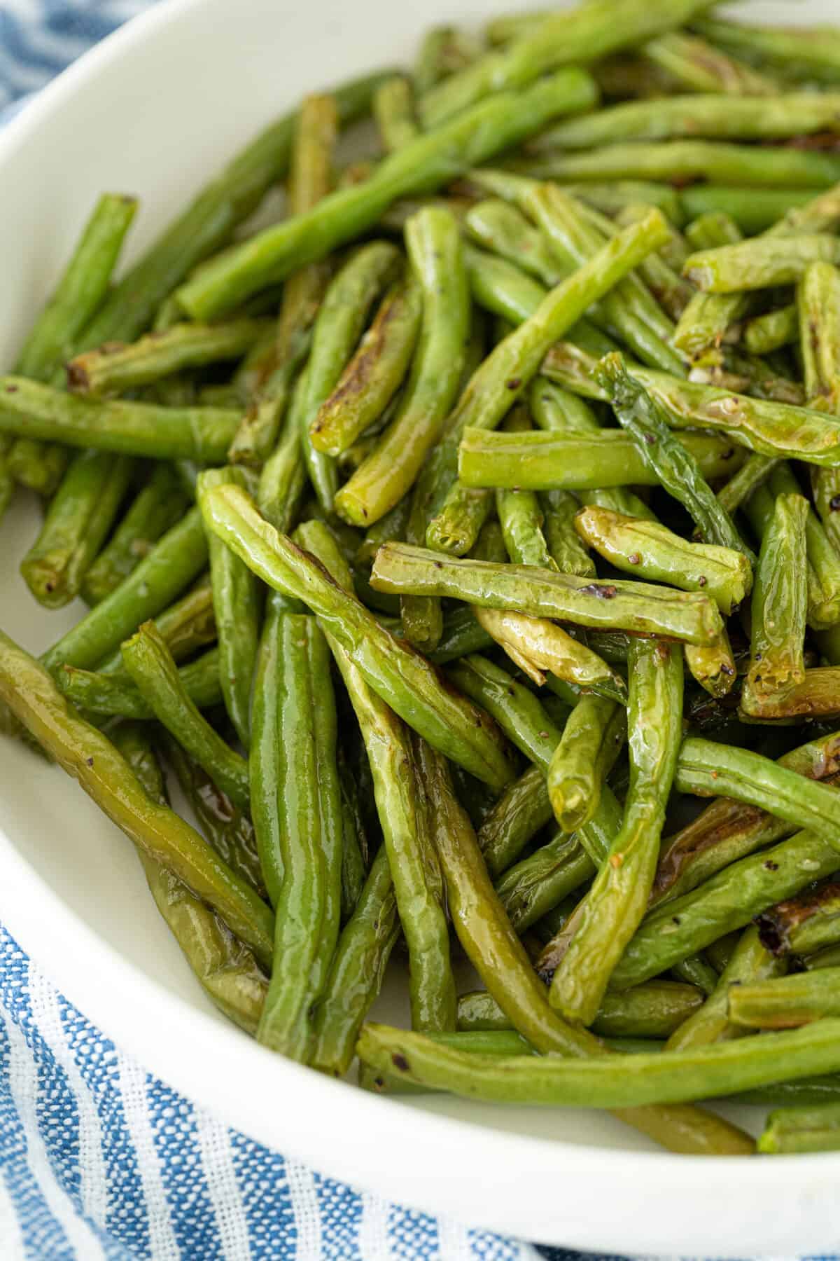 roasted green beans in a white bowl