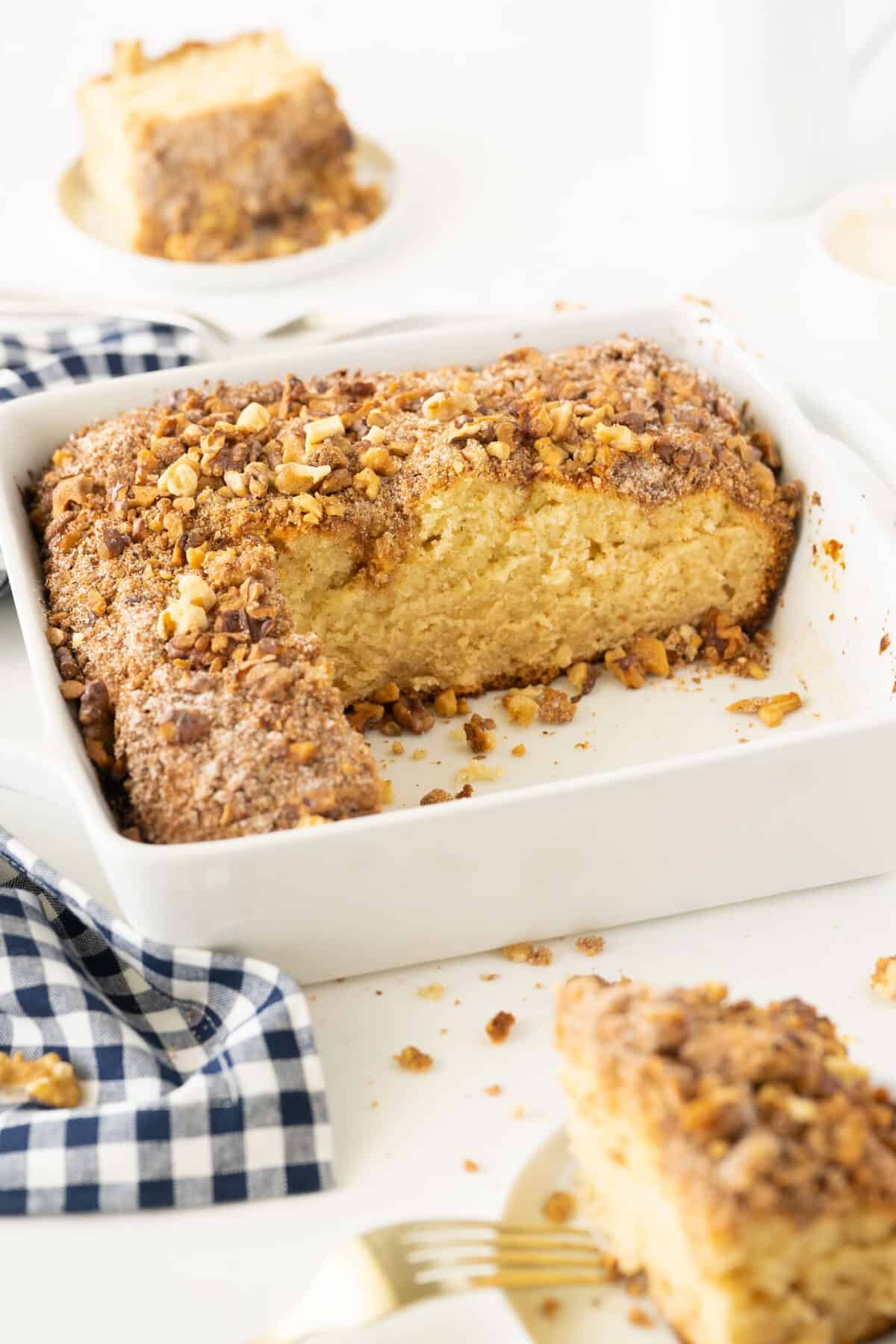 pan of sour cream coffee cake with a slice taken out