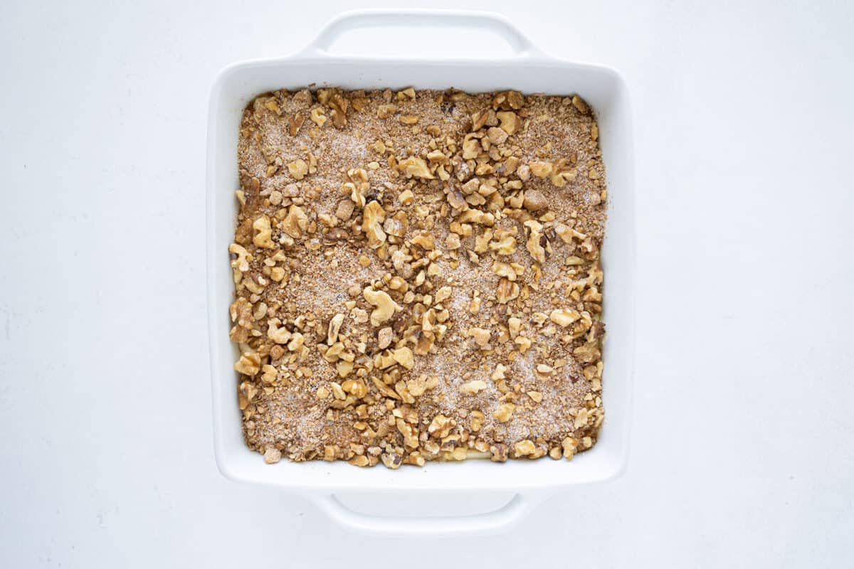 coffee cake batter in a pan with streusel on top 