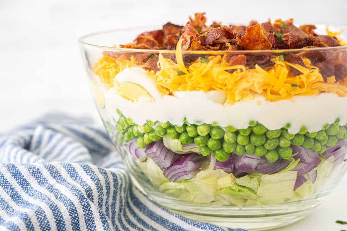 7 layer salad in a clear bowl
