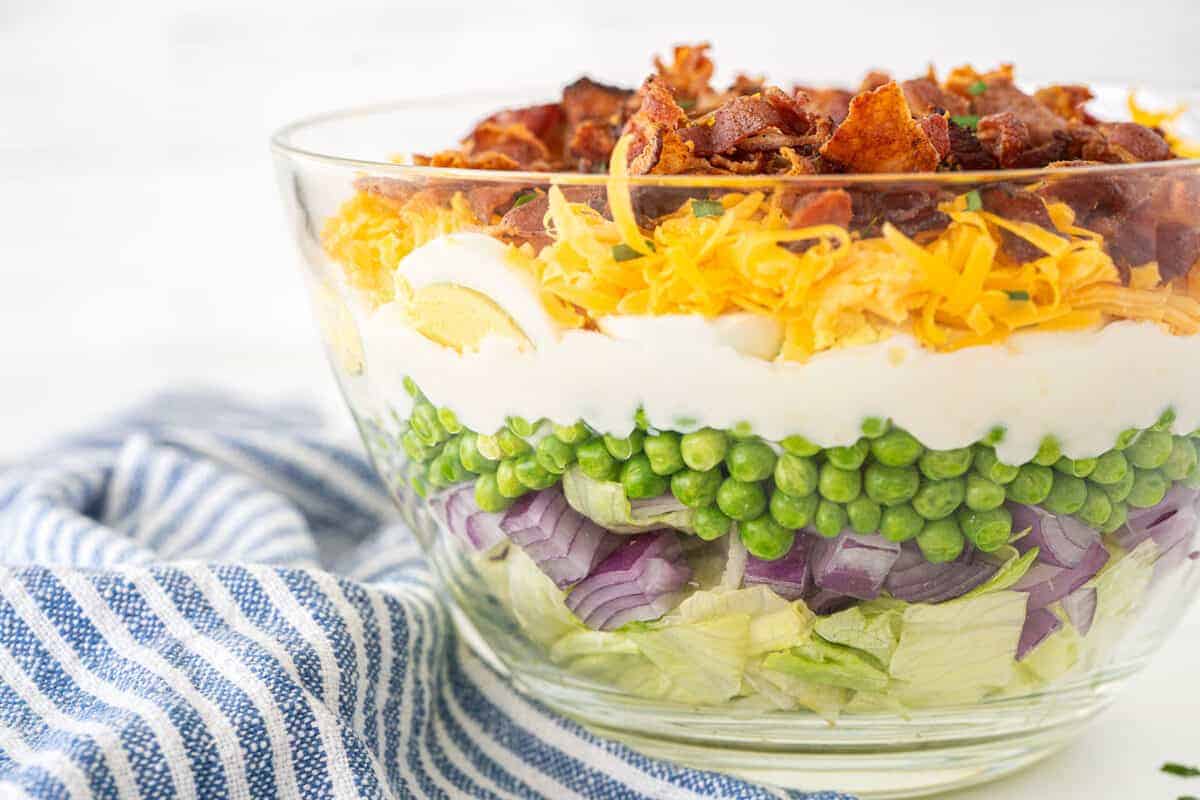 7 layer salad in a clear bowl