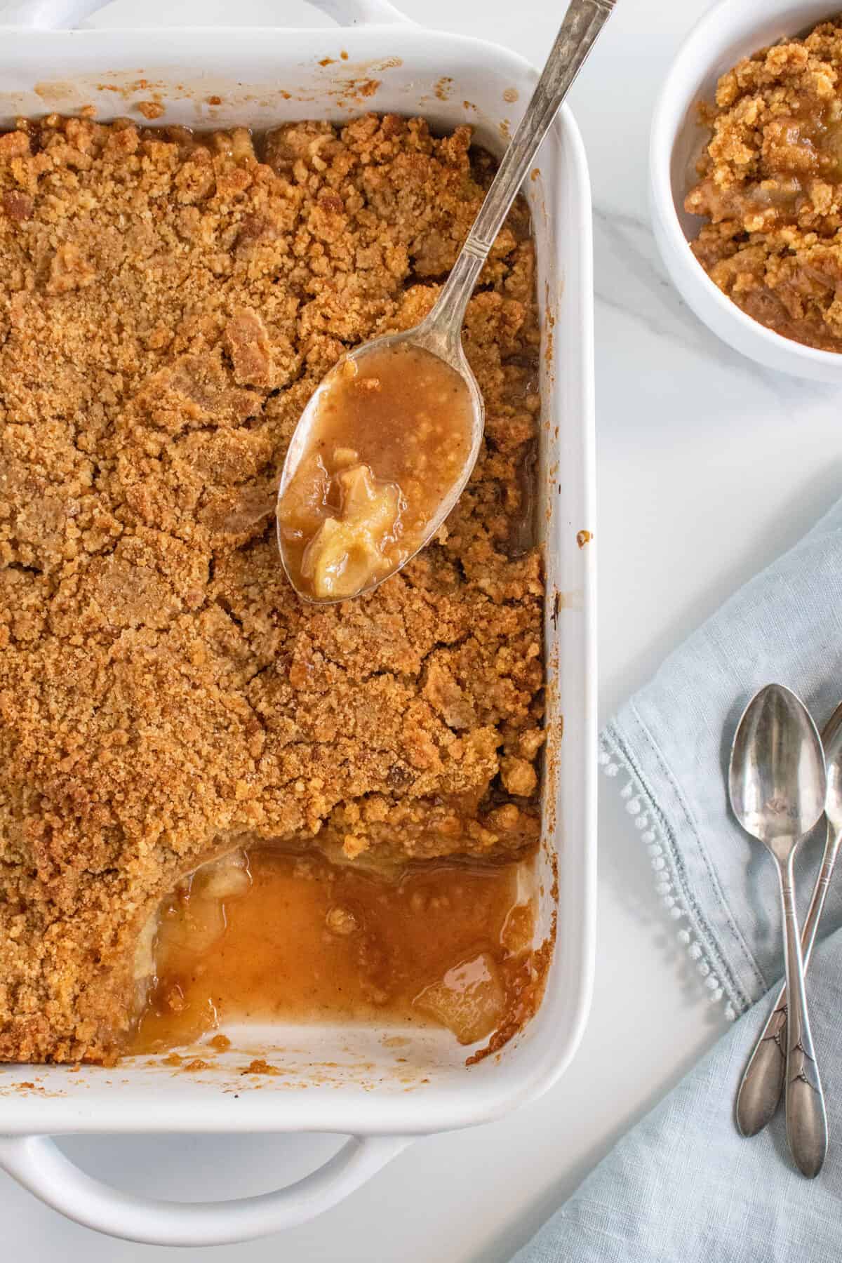 baked apple brown betty with a scoop taken out of it 