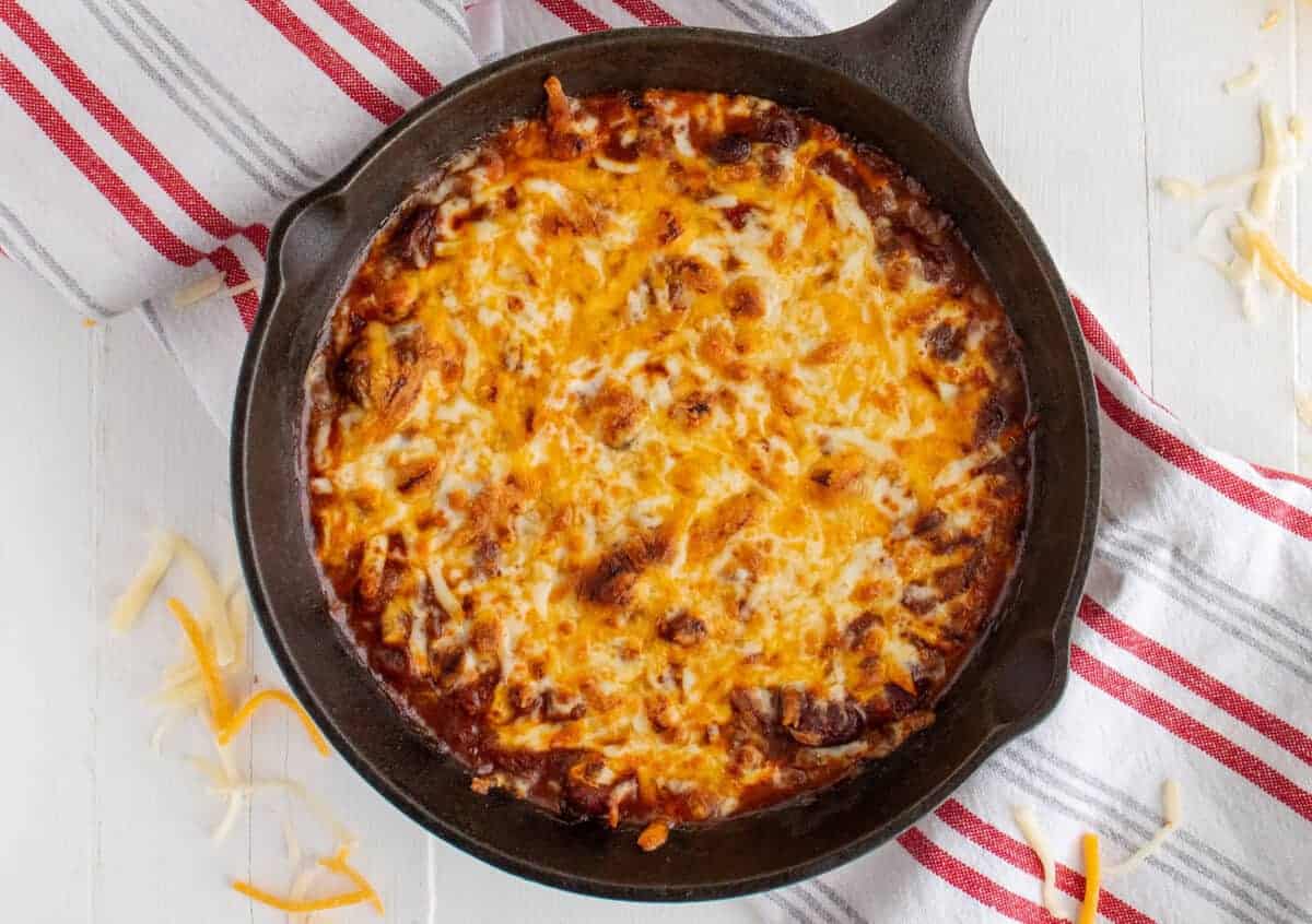 chili cheese dip in a cast iron pan