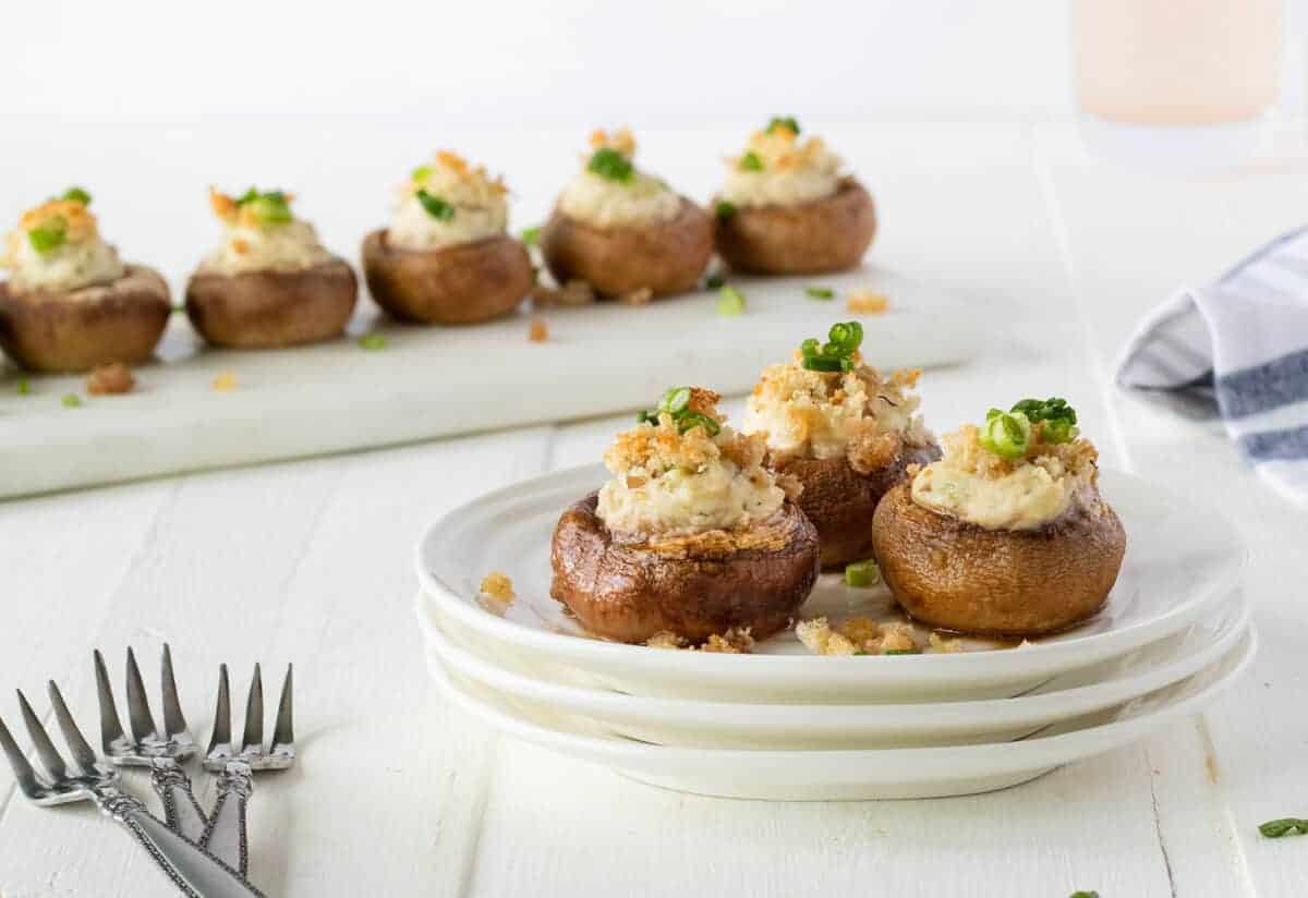 crab stuffed mushrooms on a white plate 