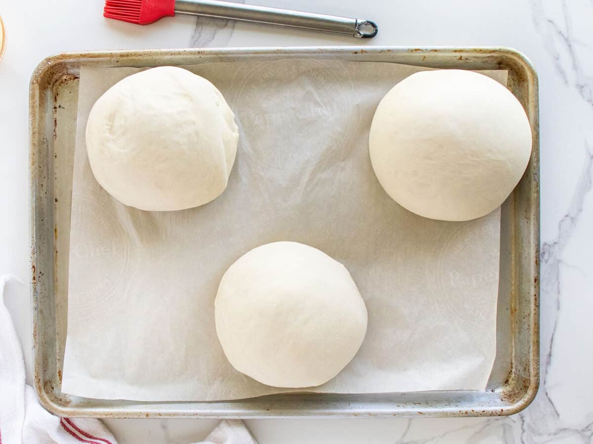Separate dough into three balls on a baking sheet