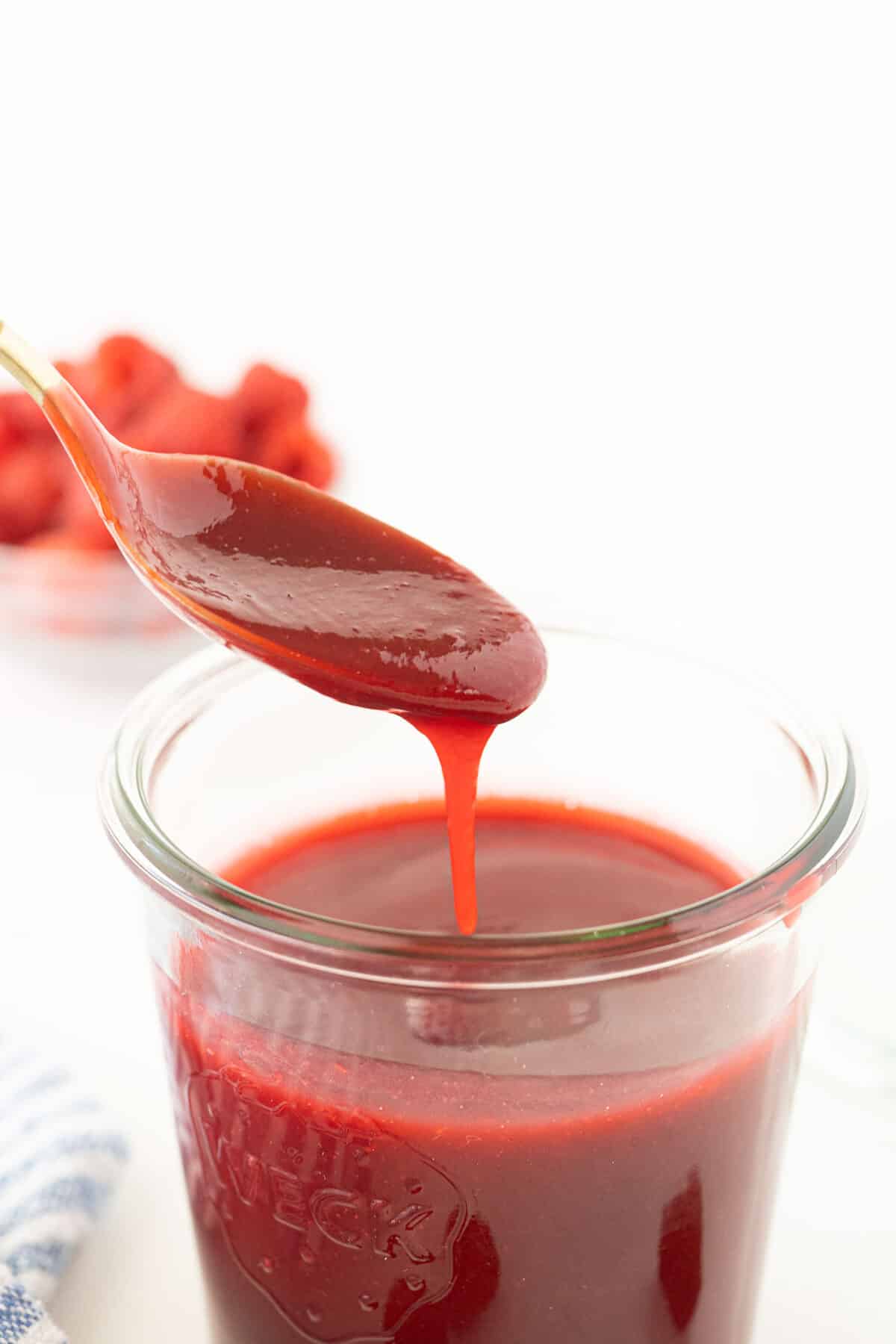 a spoon of raspberry sauce 