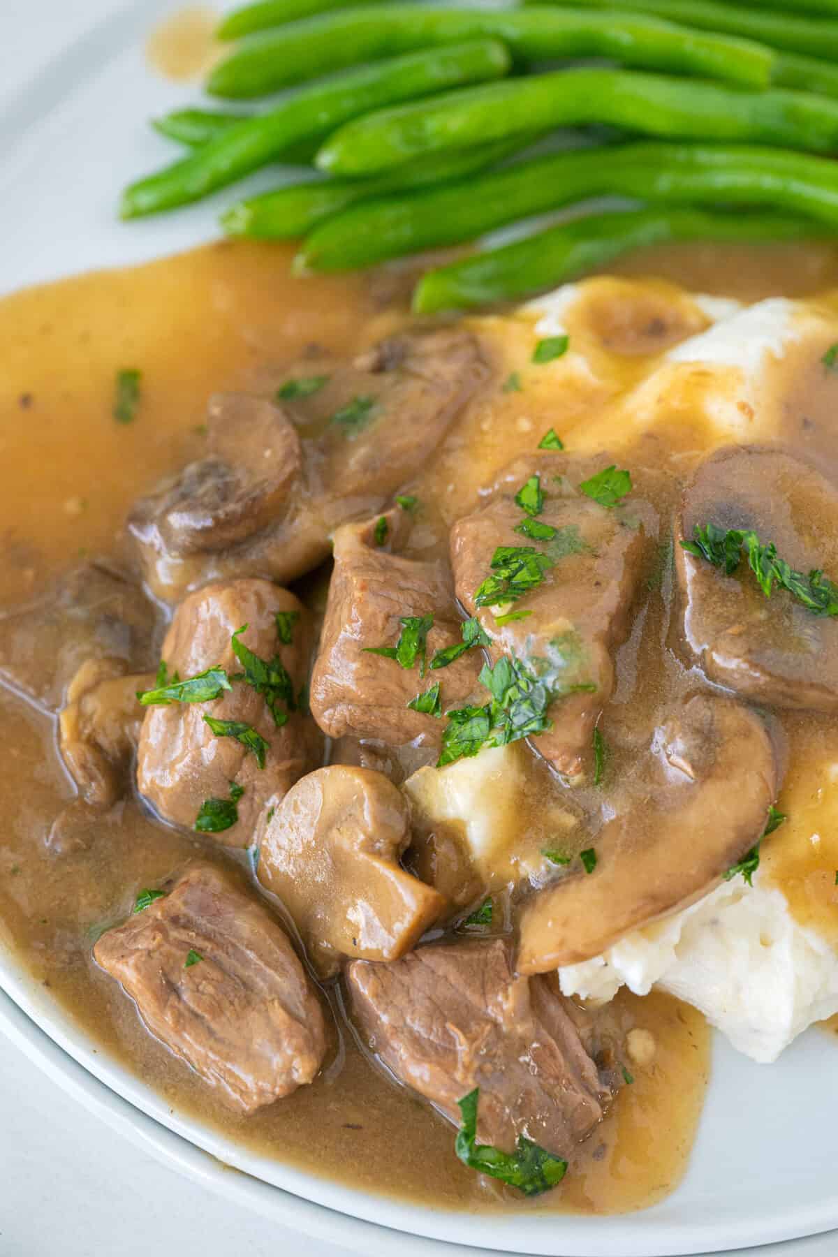 beef tips and gravy served over mashed potatoes 