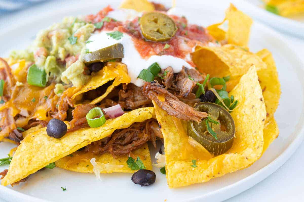 pulled pork nachos on a plate 