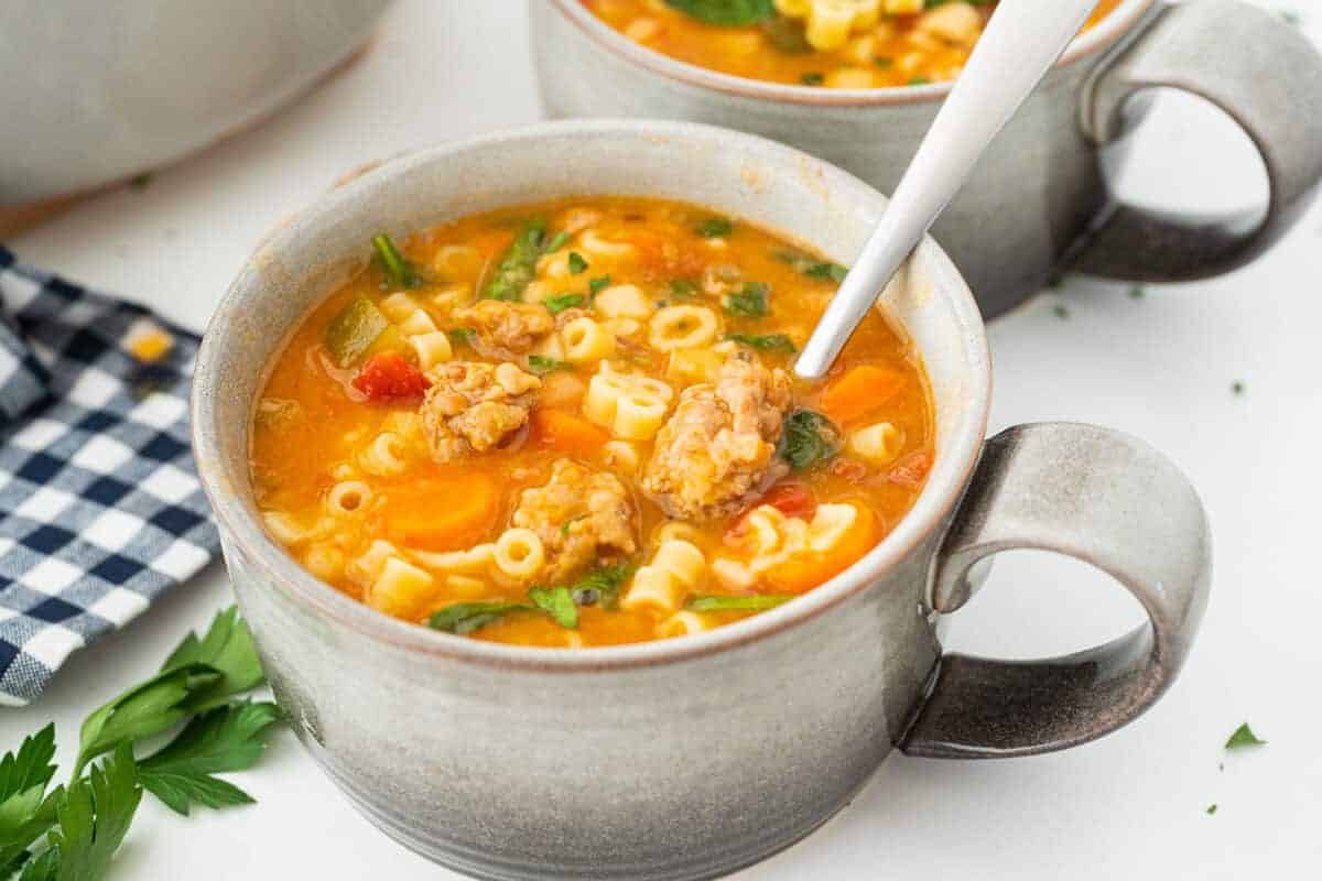 Italian sausage soup in a grey bowl 
