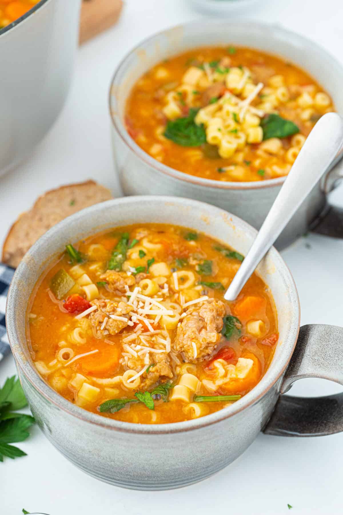 Italian sausage soup in a grey bowl
