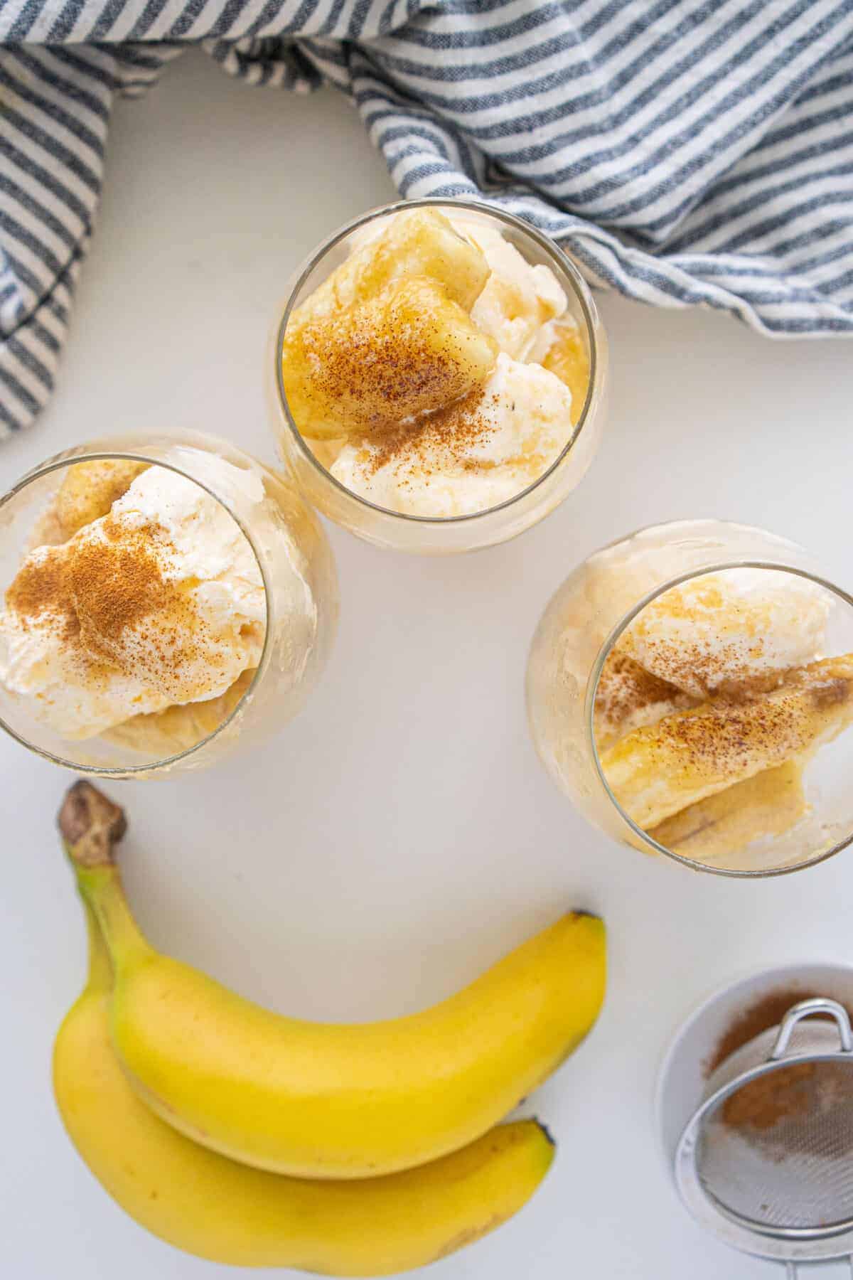 three portions of bananas foster in glass jars