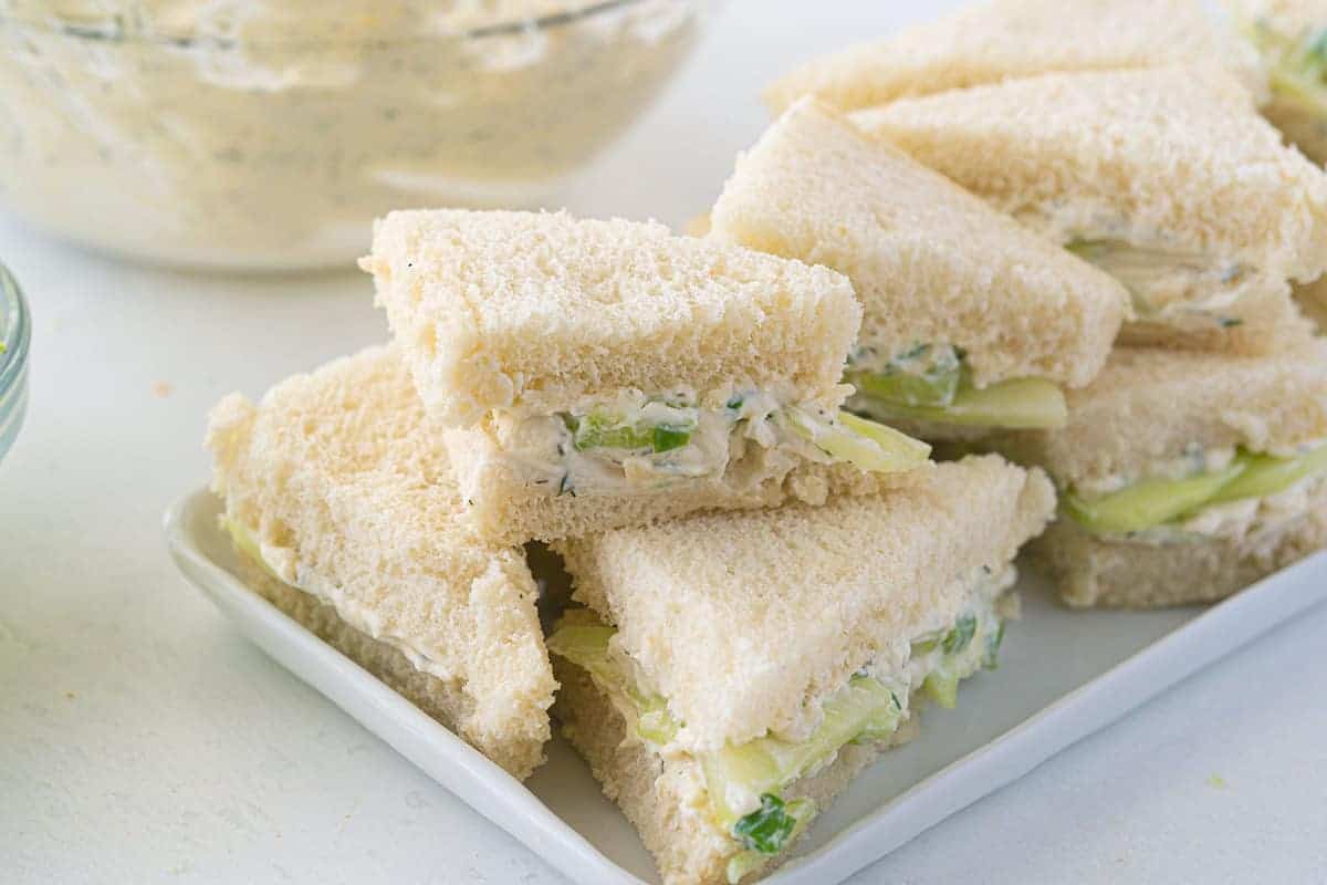 Classic cucumber sandwiches with cream cheese on white bread, cut into triangles.