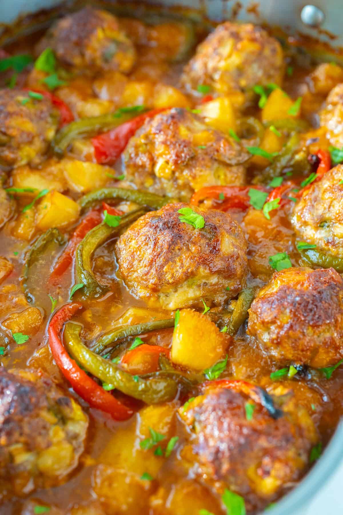 sweet and sour pork meatballs in a skillet
