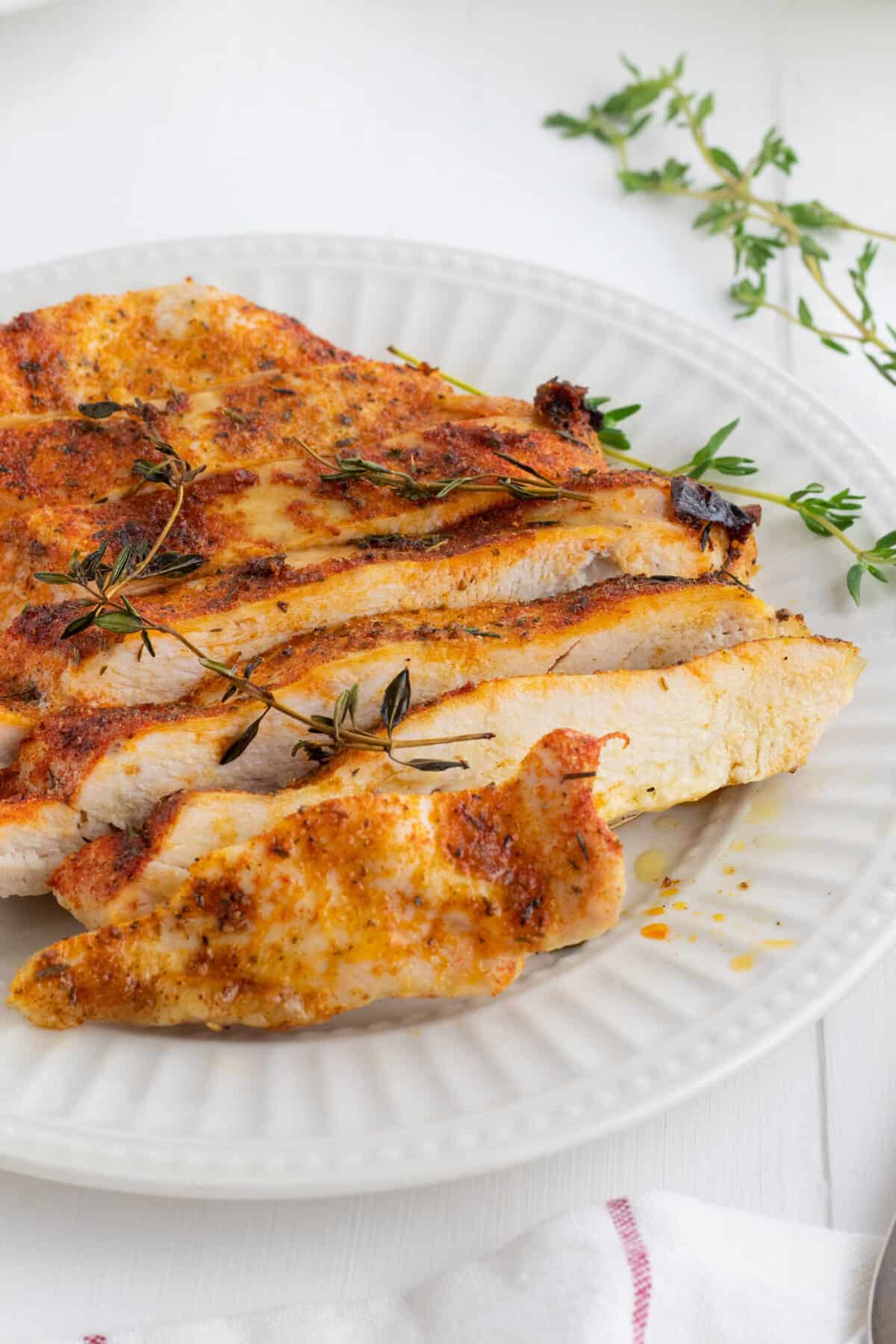 sliced chicken breast on a white plate 
