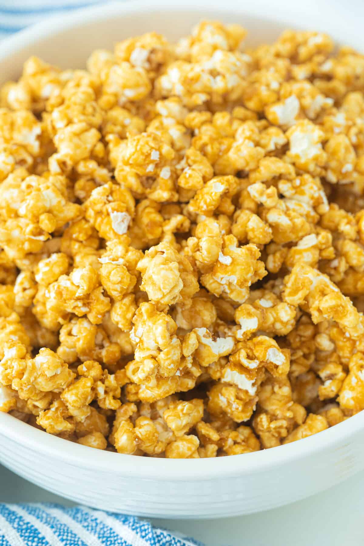 caramel popcorn in a large white bowl