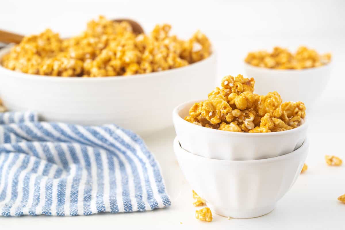 caramel popcorn in a white bowl