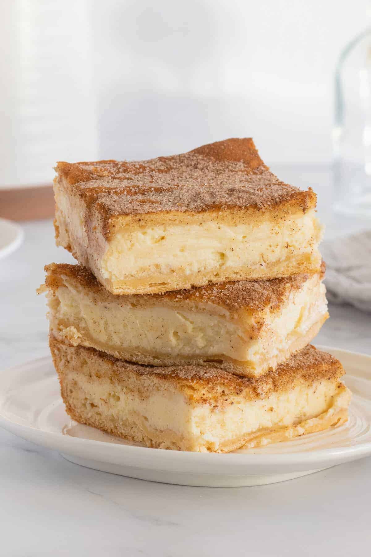 churro cheesecake bars in a stack